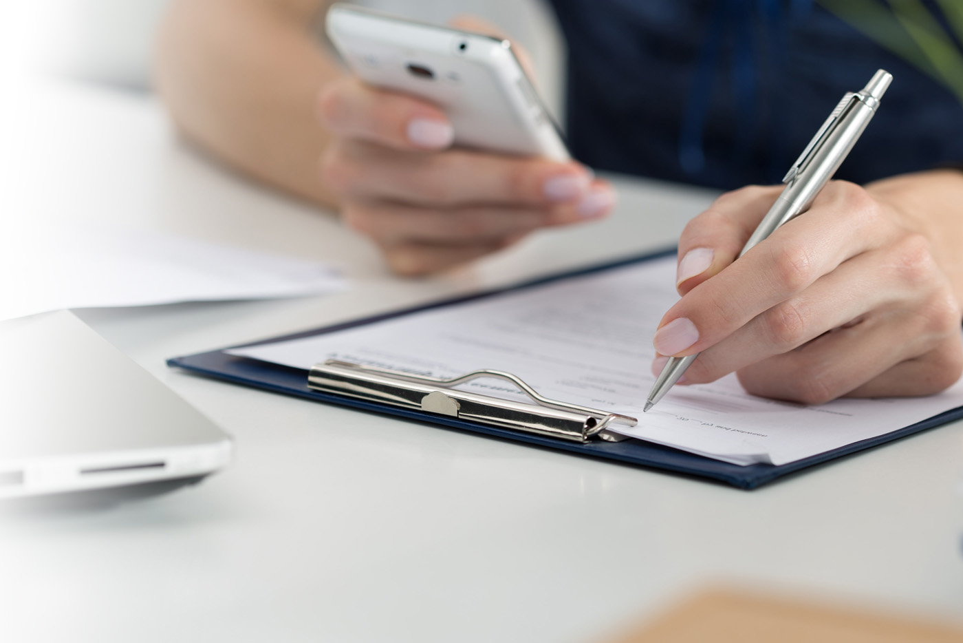 A person writing on a clipboard